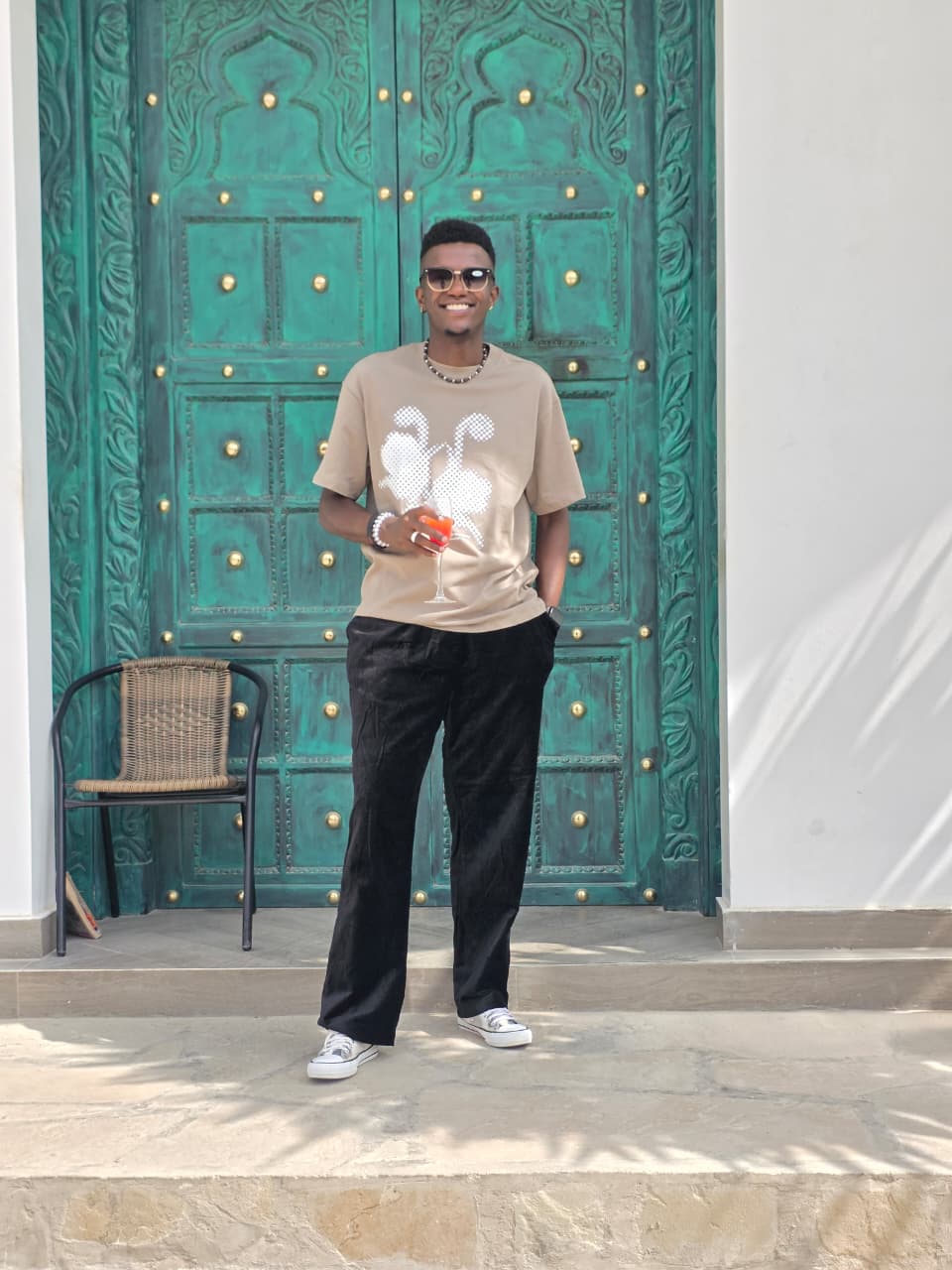 Lewis Muturi standing by a decorative doorway