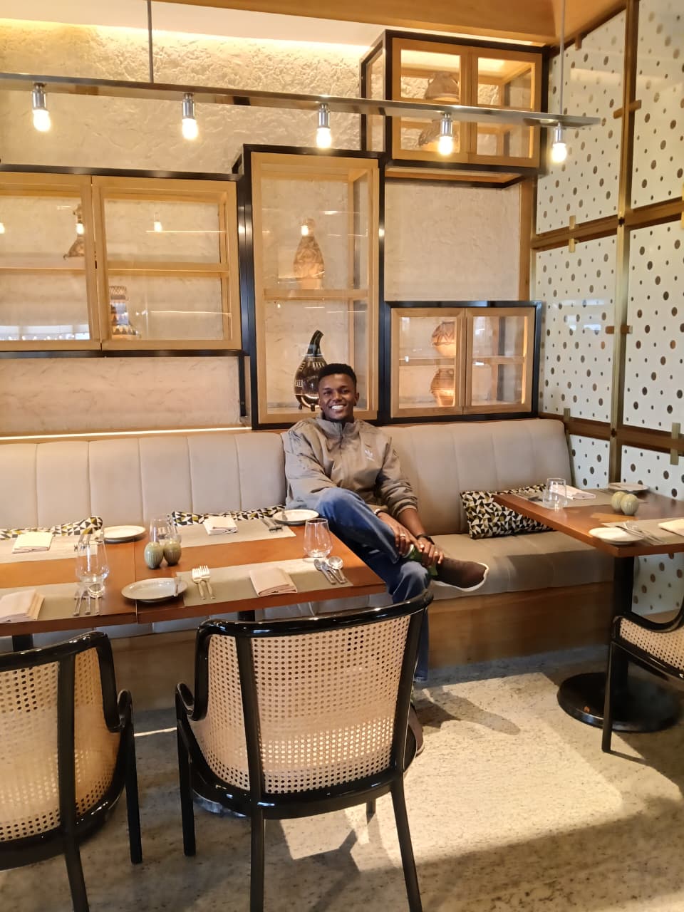 Lewis Muturi seated in an interior lounge